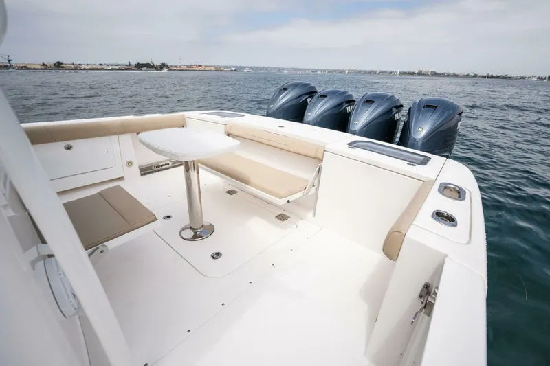 Slide: The Image of 2019 Everglades 435 Center Console boat with seating and four outboard engines. - 27