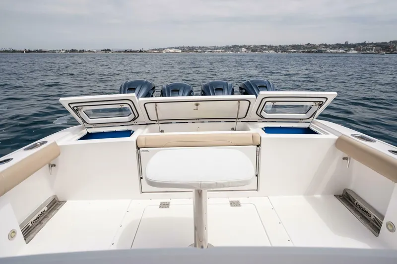 Slide: The Image of 2019 Everglades 435 Center Console boat with open storage compartments on the ocean. - 28