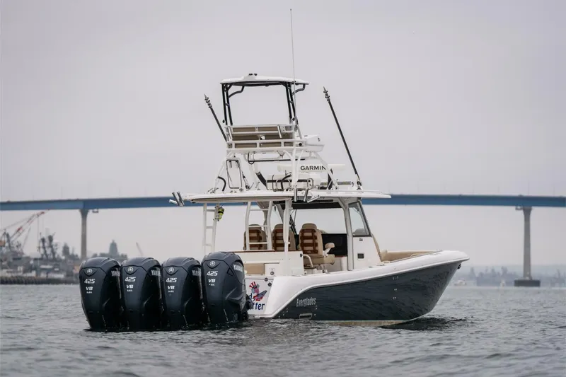 Slide: The Image of 2019 Everglades 435 Center Console boat with four outboard engines on water. - 5