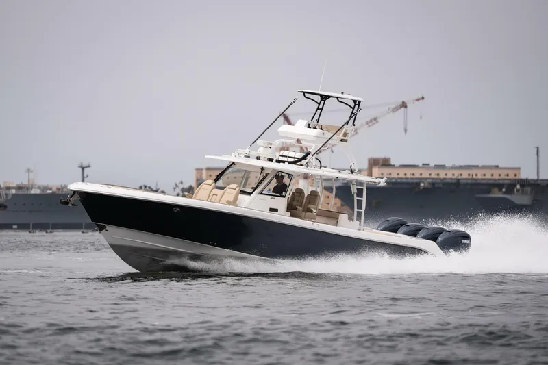 Slide: The Image of 2019 Everglades 435 Center Console boat cruising on water. - 6