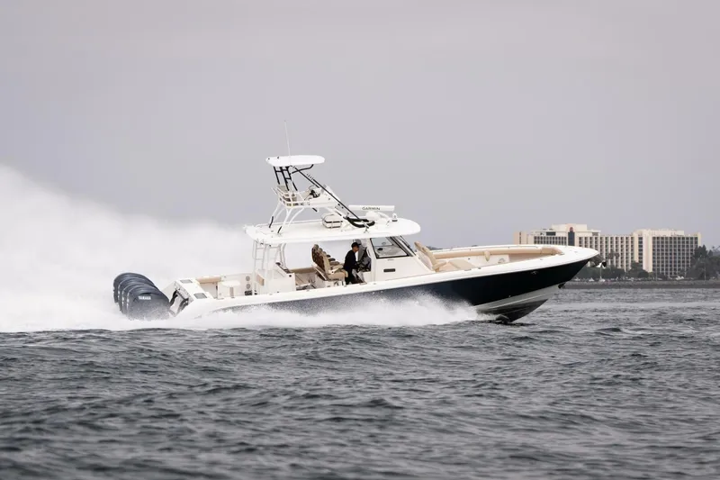 Slide: The Image of 2019 Everglades 435 Center Console boat speeding on the water. - 8