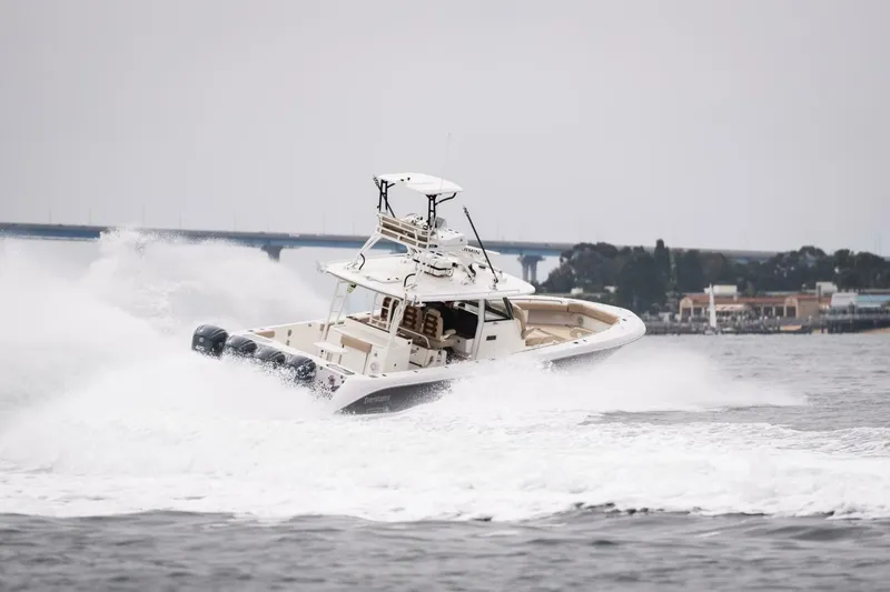 Slide: The Image of 2019 Everglades 435 Center Console boat speeding on water. - 9
