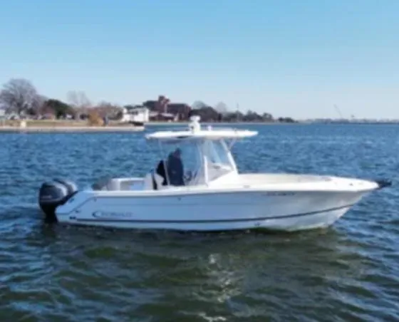 Slide: The Image of 2016 Robalo R300 Center Console boat on calm water, side view. - 0