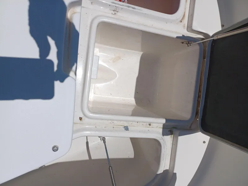 Slide: The Image of Open storage compartment on a 2016 Robalo R300 Center Console boat. - 18