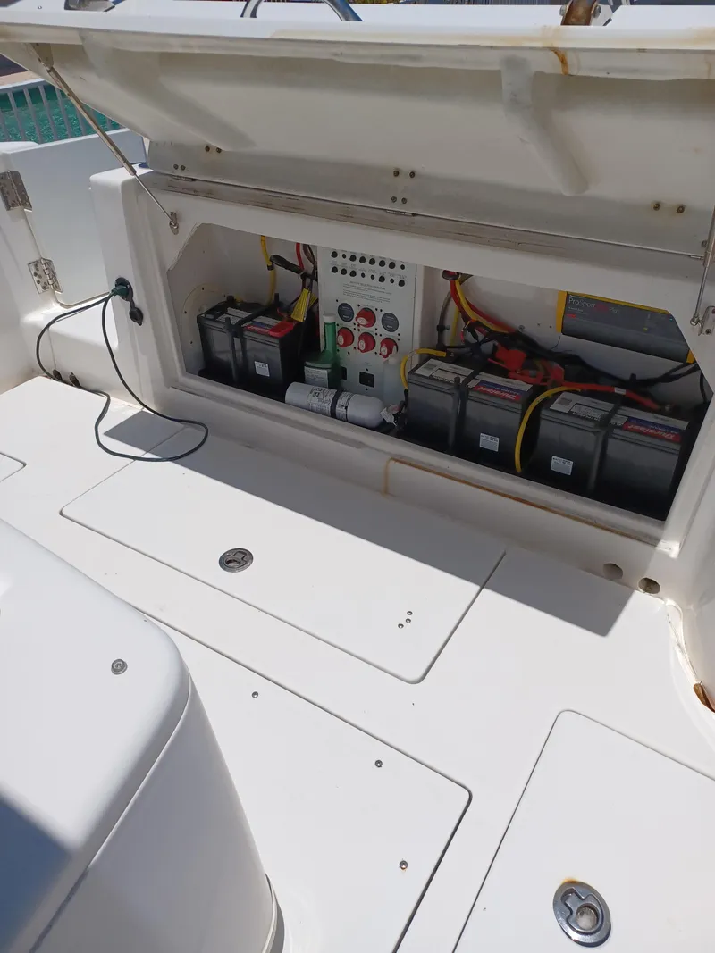 Slide: The Image of 2016 Robalo R300 Center Console boat battery compartment and control panel. - 19