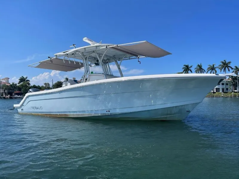 Slide: The Image of 2016 Robalo R300 Center Console boat on water, clear sky background. - 2