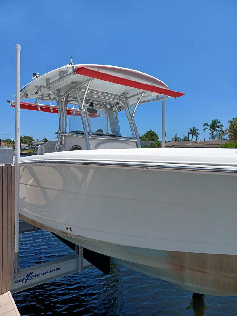 Slide: The Image of 2016 Robalo R300 Center Console boat docked on a lift. - 4