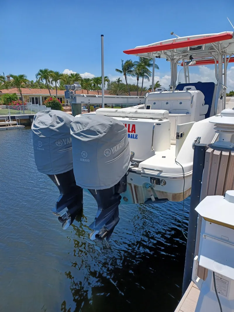 Slide: The Image of 2016 Robalo R300 Center Console boat with twin Yamaha outboard engines docked. - 6
