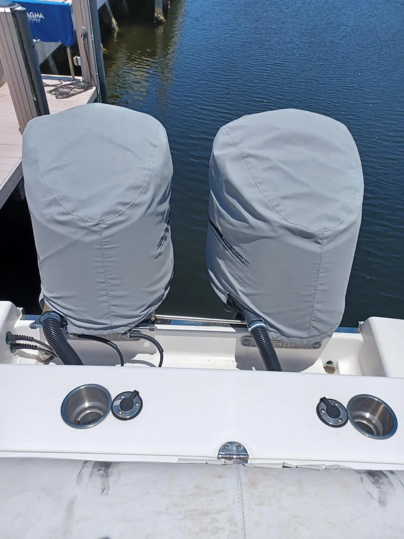 Slide: The Image of 2016 Robalo R300 Center Console with covered twin outboard motors. - 7