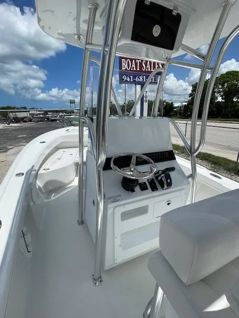 Slide: The Image of 2025 Pair Customs 21MV boat interior with steering console and seating. - 17