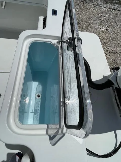 Slide: The Image of Open storage compartment on a 2025 Pair Customs 21MV boat. - 32