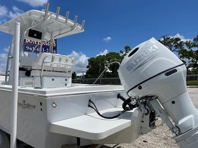 Slide: The Image of 2025 Pair Customs 21MV boat with Suzuki outboard motor under clear blue sky. - 5