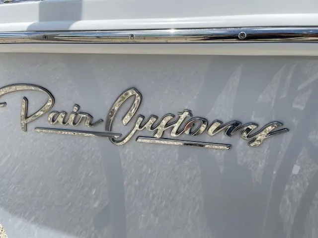 Slide: The Image of Pair Customs 21MV 2025 boat logo in chrome on white background. - 7