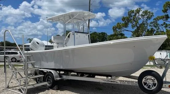 Slide: The Image of 2025 Pair Customs 21MV boat on trailer with ladder, parked outdoors under blue sky. - 8