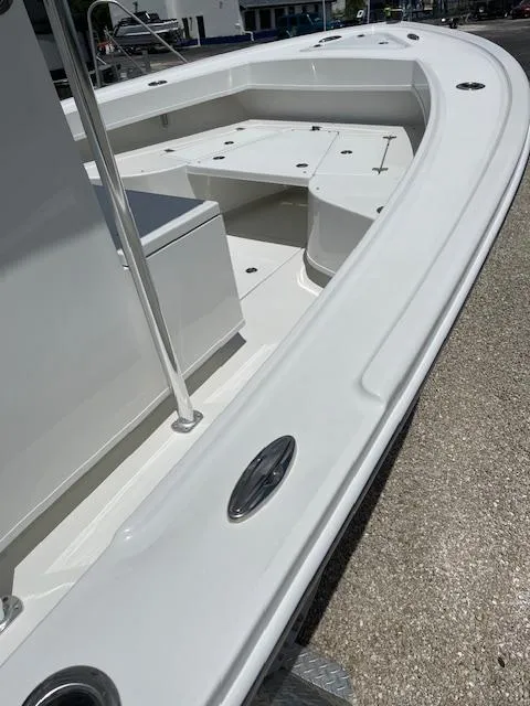 Slide: The Image of 2025 Pair Customs 21MV boat, white deck and seating, docked on a sunny day. - 9