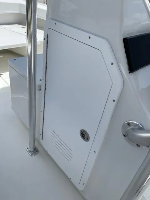 Slide: The Image of 2025 Pair Customs 21MV boat interior with white storage compartment. - 22