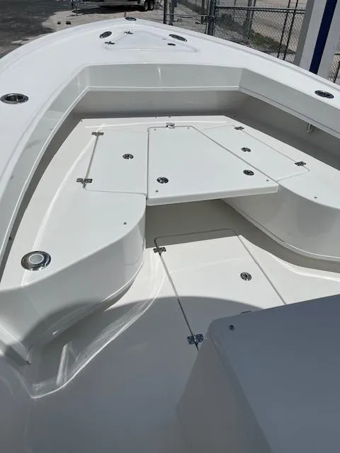 Slide: The Image of 2025 Pair Customs 21MV boat deck with storage compartments and seating. - 23