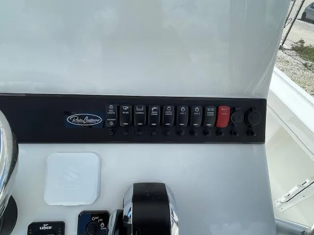 Slide: The Image of Control panel of a 2025 Pair Customs 21MV boat with various switches and buttons. - 28