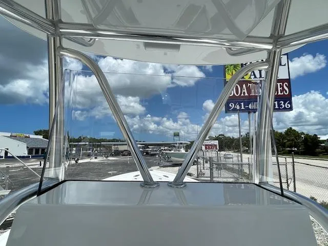 Slide: The Image of View from the helm of a 2025 Pair Customs 21MV boat at a marina. - 30