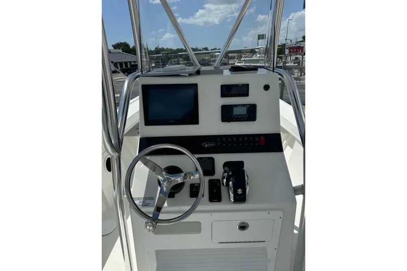 Slide: The Image of 2025 Pair Customs 21MV boat dashboard with steering wheel and electronic controls. - 33