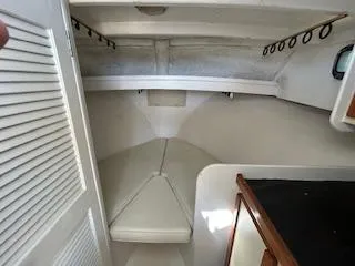 Slide: The Image of Interior cabin of 1989 Markley 35 Ft. Deadrise boat with white cushioned seating. - 11