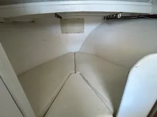 Slide: The Image of Interior cabin of 1989 Markley 35 Ft. Deadrise boat, featuring white seating and storage. - 12