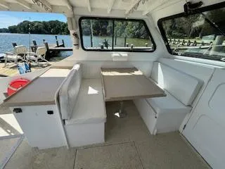 Slide: The Image of Interior of a 1989 Markley 35 Ft. Deadrise boat with seating and table. - 13