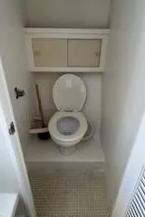 Slide: The Image of Compact bathroom in 1989 Markley 35 Ft. Deadrise boat with toilet and storage cabinet. - 17