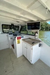 Slide: The Image of 1989 Markley 35 Ft. Deadrise boat interior with steering console and mounted screen. - 18