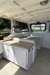 Slide: The Image of Interior of a 1989 Markley 35 Ft. Deadrise boat with seating and storage. - 19