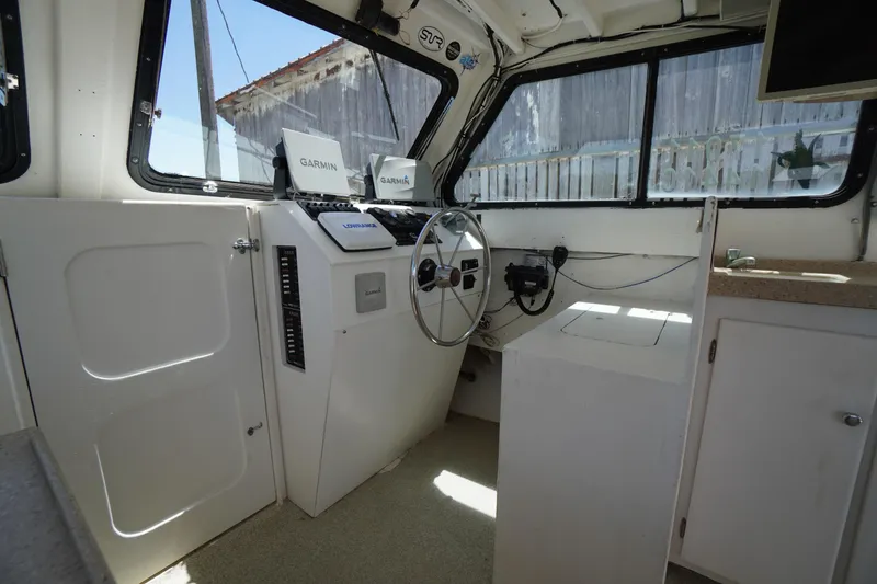 Slide: The Image of Interior of a 1989 Markley 35 Ft. Deadrise boat with Garmin navigation systems. - 23
