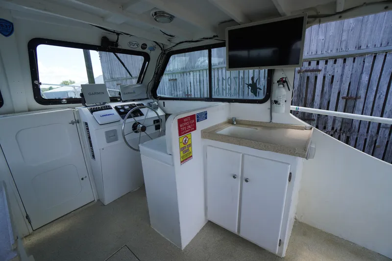 Slide: The Image of Interior of a 1989 Markley 35 Ft. Deadrise boat with navigation equipment and sink. - 27