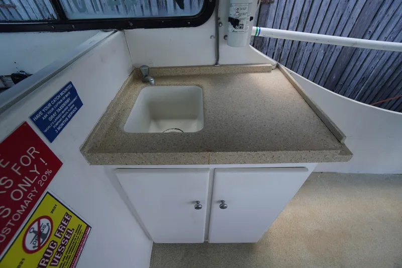 Slide: The Image of 1989 Markley 35 Ft. Deadrise boat interior with sink and countertop. - 28