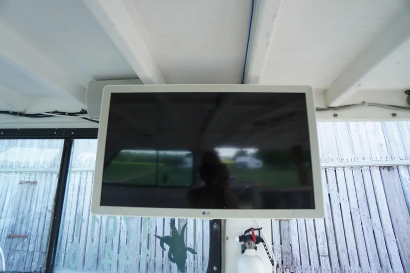 Slide: The Image of Wall-mounted LG TV inside a 1989 Markley 35 Ft. Deadrise boat. - 29