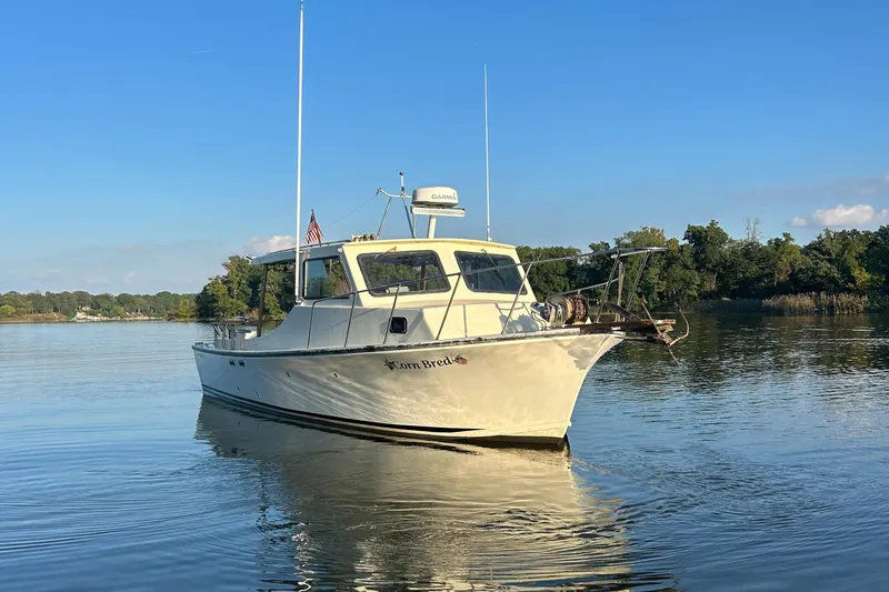 Slide: The Image of 1998 Markley 35 Ft. Deadrise boat on calm water, clear sky background. - 3