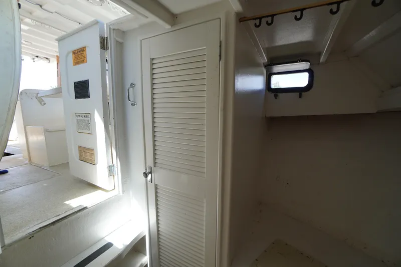 Slide: The Image of Interior of a 1989 Markley 35 Ft. Deadrise boat, featuring a cabin with a louvered door. - 34
