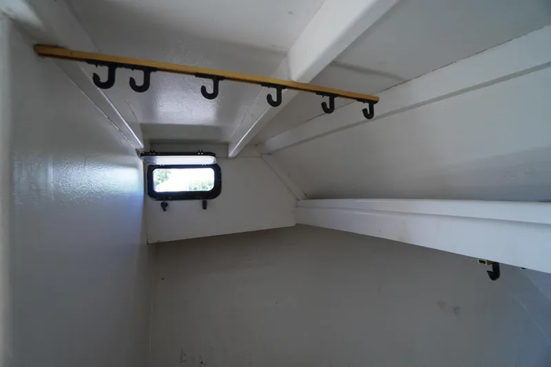 Slide: The Image of Interior of 1989 Markley 35 Ft. Deadrise boat with hooks and small window. - 38