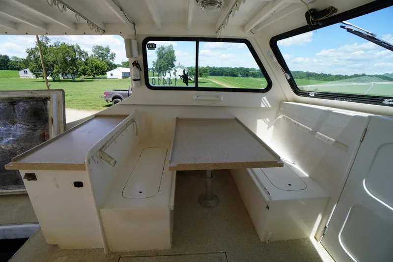 Slide: The Image of Interior of a 1989 Markley 35 Ft. Deadrise boat with seating and table. - 43