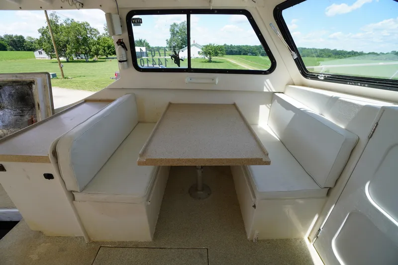 Slide: The Image of Interior of 1989 Markley 35 Ft. Deadrise boat with dining area and windows. - 45