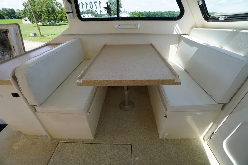 Slide: The Image of Interior of 1989 Markley 35 Ft. Deadrise boat with dining area and cushioned seating. - 46