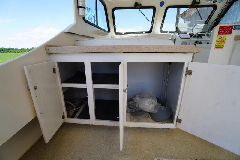Slide: The Image of Open storage cabinet on 1989 Markley 35 Ft. Deadrise boat deck. - 50
