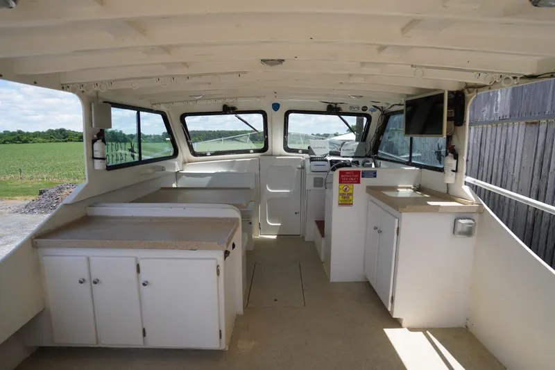 Slide: The Image of Interior of a 1989 Markley 35 Ft. Deadrise boat with spacious cabin and helm. - 51