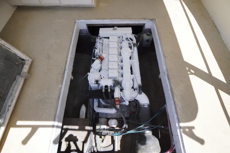 Slide: The Image of Engine compartment of a 1989 Markley 35 Ft. Deadrise boat, showcasing a white engine. - 52