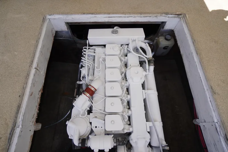 Slide: The Image of Engine compartment of a 1989 Markley 35 Ft. Deadrise boat, showcasing a white engine. - 53