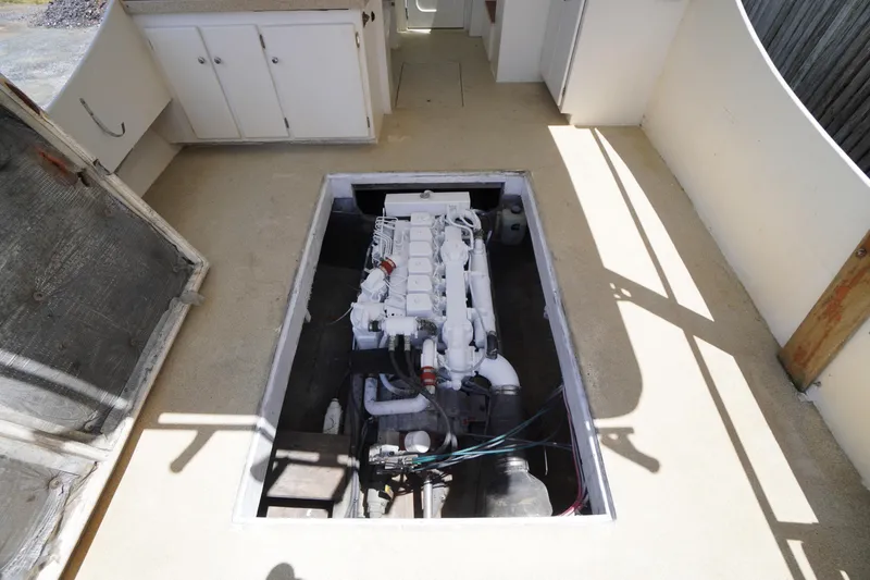 Slide: The Image of Engine compartment of a 1989 Markley 35 Ft. Deadrise boat, showcasing the engine layout. - 54