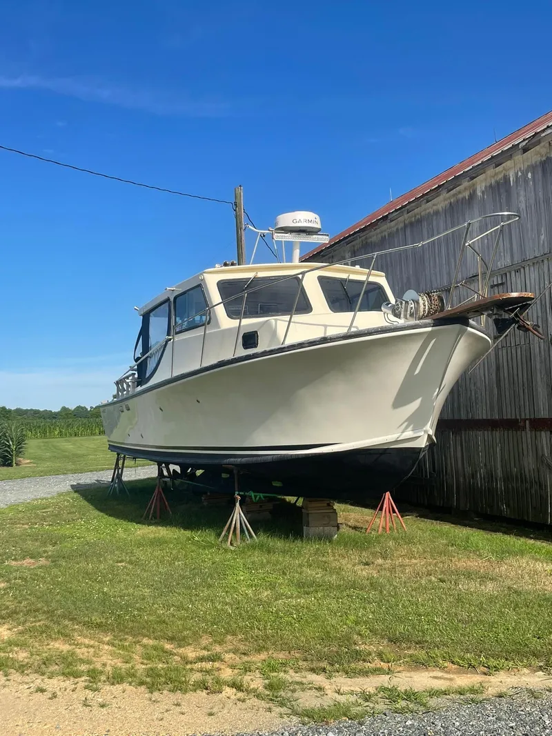 Slide: The Image of 1998 Markley 35 Ft. Deadrise boat on stands near a barn. - 6