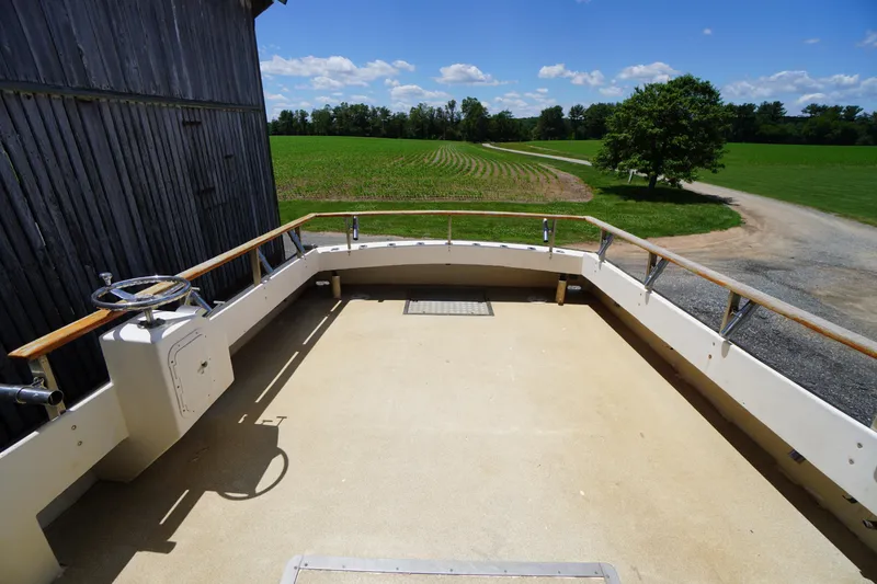 Slide: The Image of 1989 Markley 35 Ft. Deadrise boat deck with rural landscape background. - 60