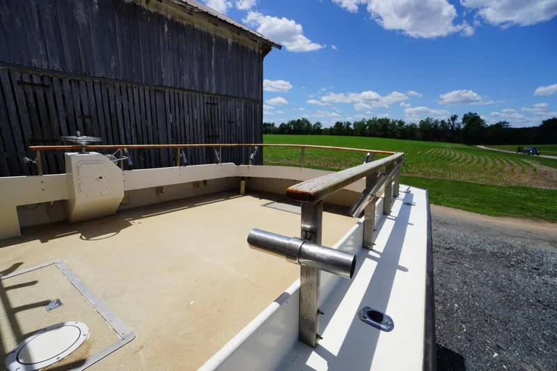 Slide: The Image of 1989 Markley 35 Ft. Deadrise boat docked near a rustic barn under a blue sky. - 64