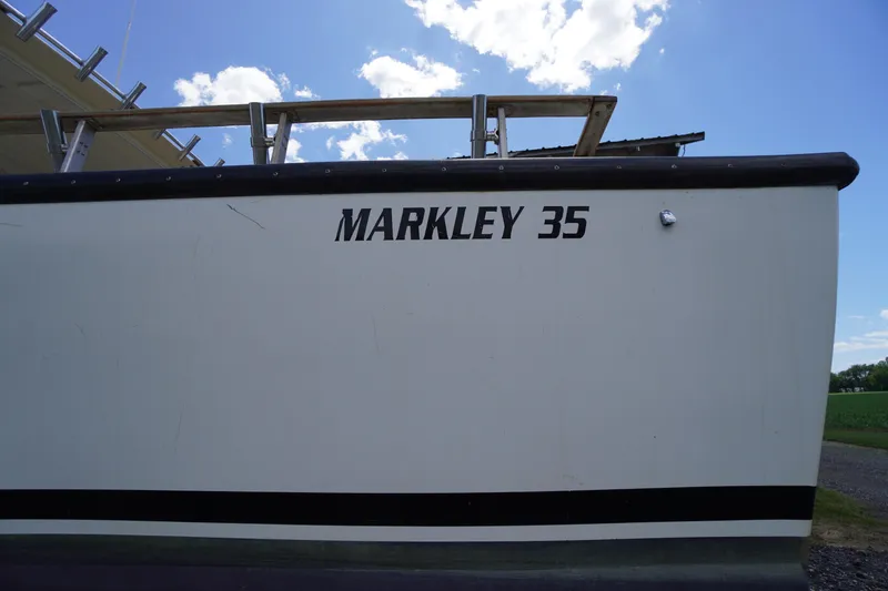 Slide: The Image of 1989 Markley 35 Ft. Deadrise boat side view under a clear blue sky. - 73