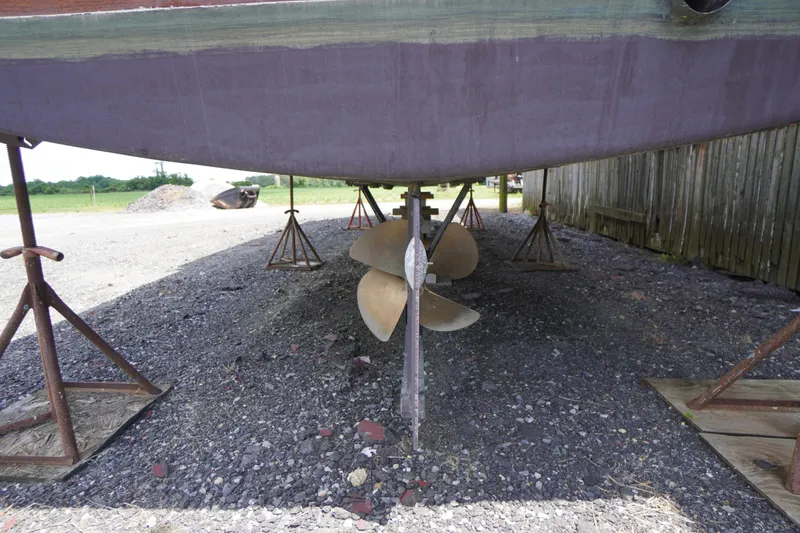 Slide: The Image of 1989 Markley 35 Ft. Deadrise boat on stands, showing propeller and hull underside. - 78